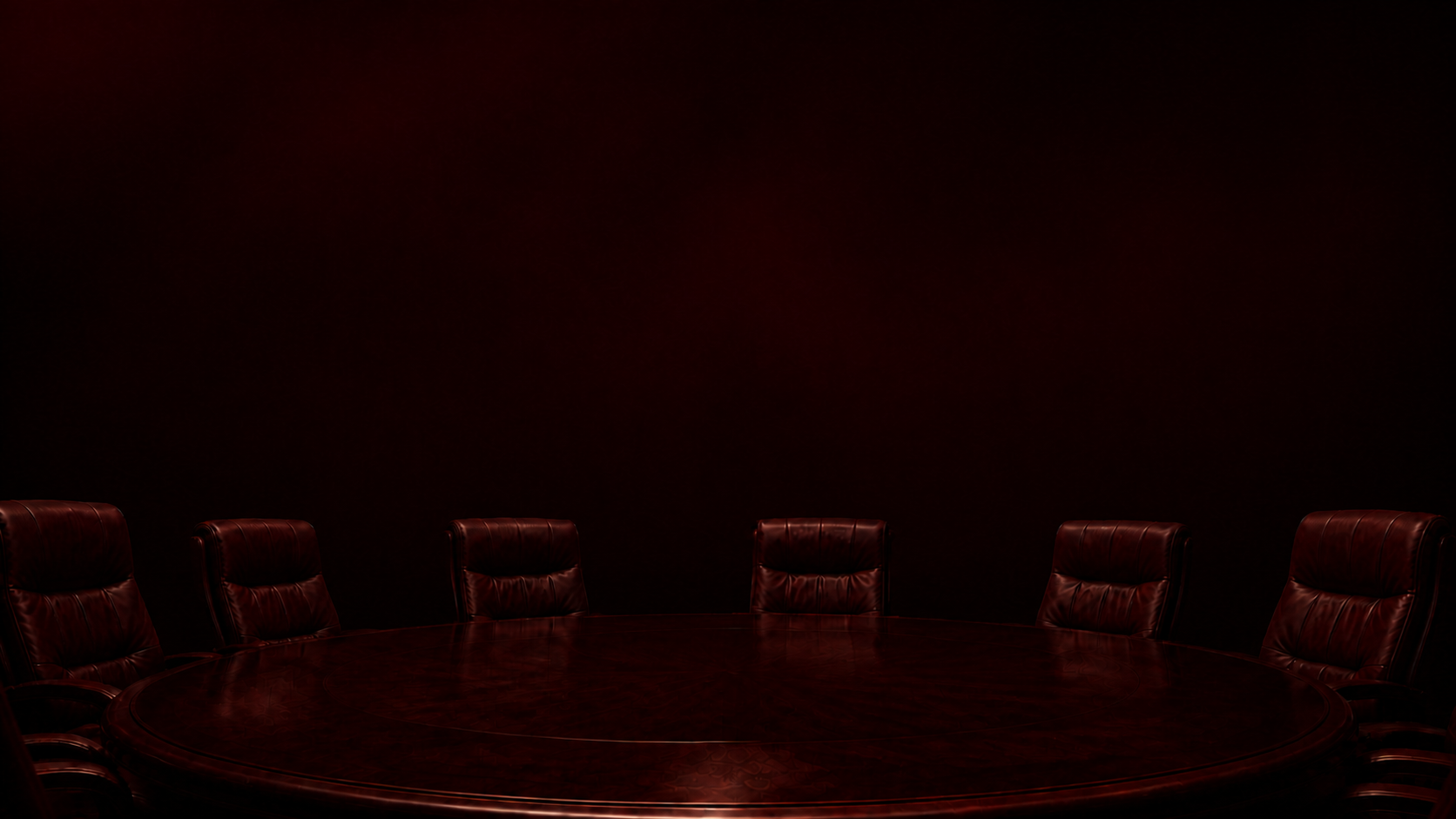 Una boardroom bordeaux con tavolo rotondo.